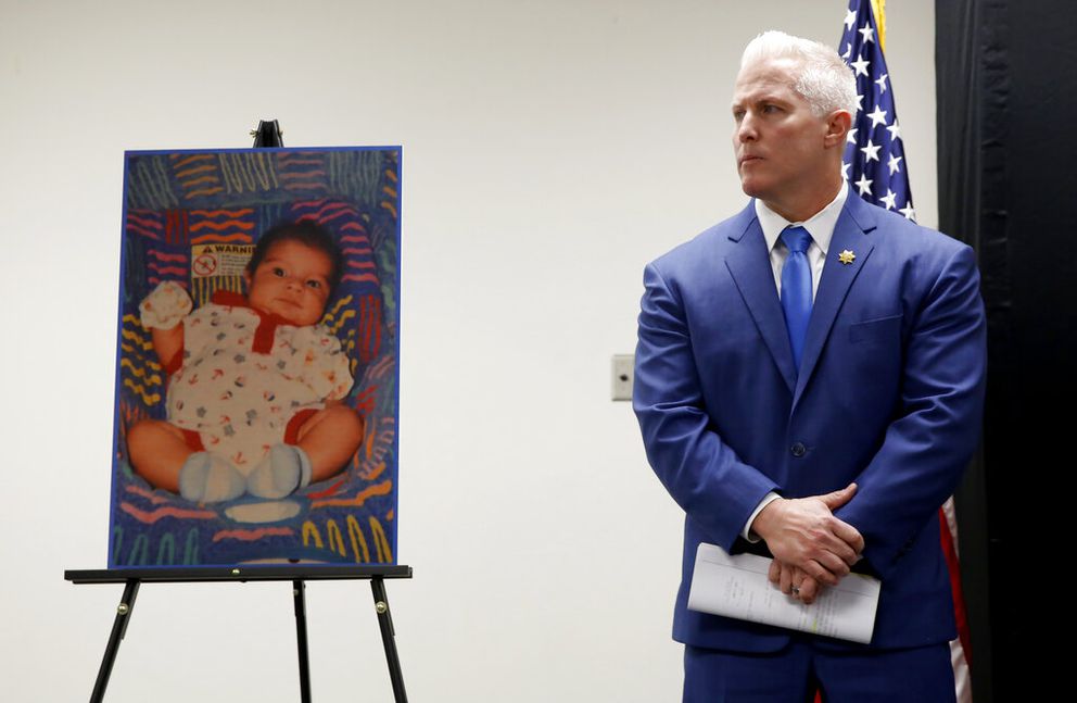 Yolo County District Attorney Jeff Reisig stands next to a photo of Kato Krow Perez, born in 2001, one of five infants believed to be killed by their father, during a news conference in Woodland, Calif., Monday, Jan. 27, 2020. Paul Perez, the father of the infants, has been arrested in the decades-old killings of five of his infant children, a case the sheriff said had haunted his agency for years, the Yolo County Sheriff's Office said Monday, Jan. 27, 2020. (AP Photo/Rich Pedroncelli)