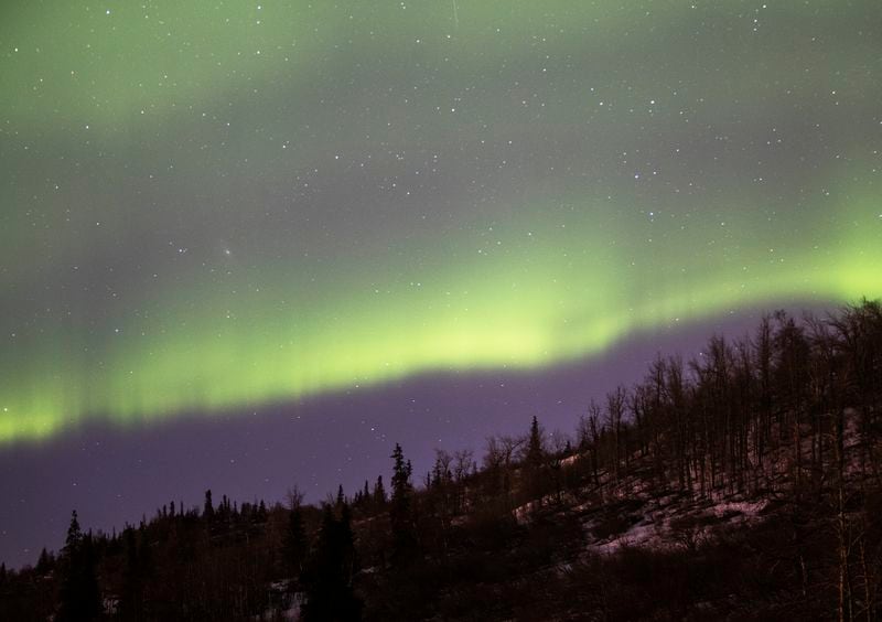 The northern lights appear over a hillside near Arctic Valley Ski Area shortly after 1 a.m. March 31, 2022. (Emily Mesner / ADN)