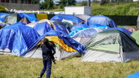 Hundreds of asylum-seekers are camped out near Seattle. There’s a vacant motel next door.