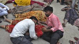 More than 100 dead and scores injured in stampede at religious event in India