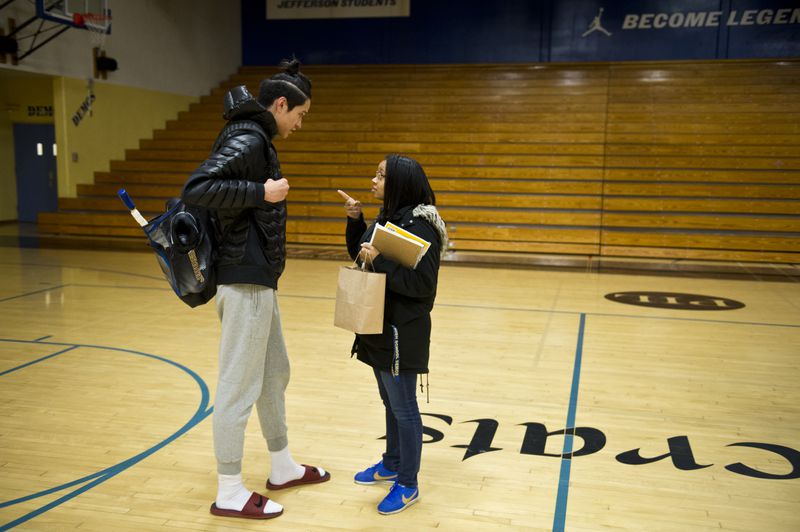 Sara Lawrence, right, tells Kamaka Hepa to stay out of trouble before he leaves the gym at Jefferson High School. “He’s one of my good students,” said Lawrence, of Self-Enhancement Inc., which works in the school to provide support services for students. (Marc Lester / ADN)