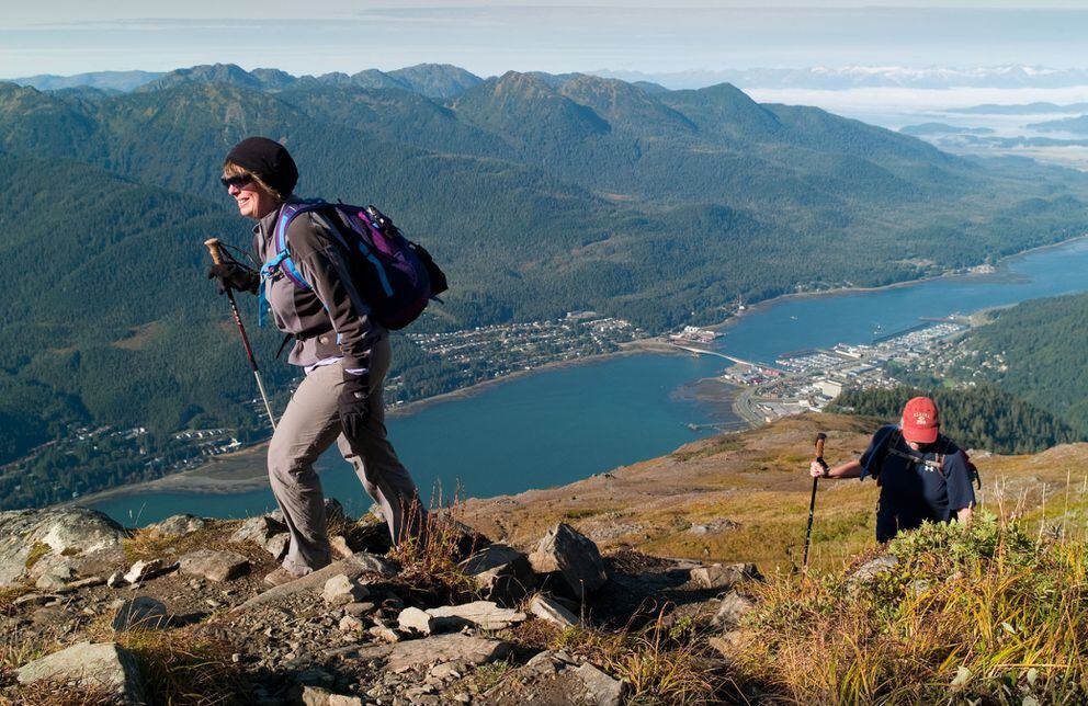 Shirley Carlson, left, and Julie Coghill take advantage of sunny weather and the last day of public operations of the Mount Roberts Tramway to hike up to Gold Ridge in Juneau on Wednesday, September 25, 2013. (AP Photo/The Juneau Empire, Michael Penn)