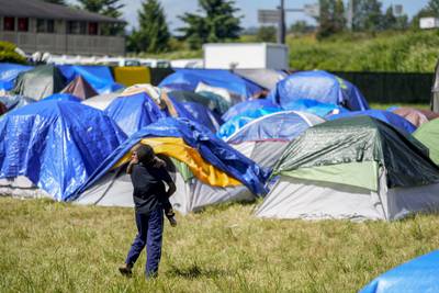 Hundreds of asylum-seekers are camped out near Seattle. There’s a vacant motel next door.