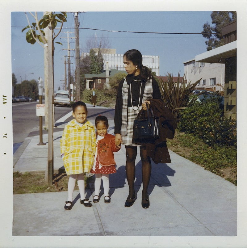 This January 1970 photo provided by the Kamala Harris campaign shows her, left, with her sister, Maya, and mother, Shyamala, outside their apartment in Berkeley, Calif., after her parents' separation. (Kamala Harris campaign via AP)