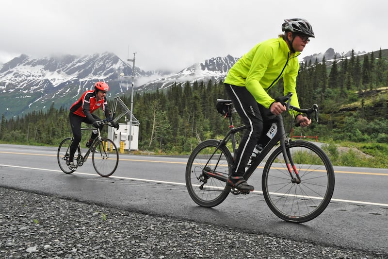 Members of the four-person "MCMN Hammer" team take part in a relay exchange during the 200-mile Fireweed bike race to Valdez on Saturday, July 13, 2024, along the Richardson Highway heading toward Thompson Pass. (Vicky Ho / ADN)