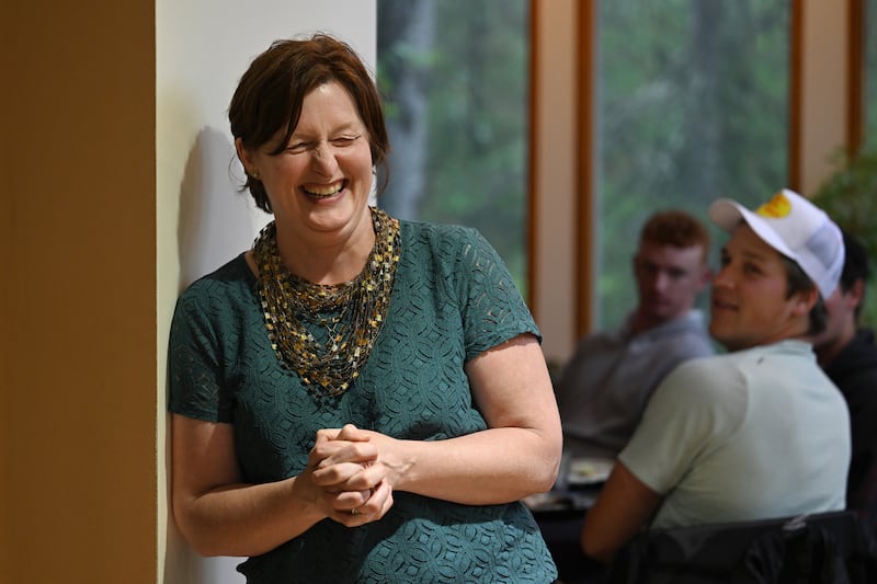 Jennifer Mattingly shares a moment with players during dinner at her Hillside home. (Bill Roth / ADN) 