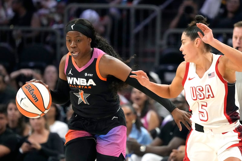 Arike Ogunbowale, left, of Team WNBA, left, steals a pass intended for Kelsey Plum (5), of Team USA, during the second half of a WNBA All-Star basketball game Saturday, July 20, 2024, in Phoenix. (AP Photo/Ross D. Franklin)