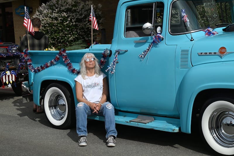 Nat Gardner takes in a little sunshine while waiting for the Anchorage July 4th parade to begin.  She restored her 1956 Ford F-100, which she has owned for almost 20 years.  The parade and festival is held at the Delaney Park Strip, July 4, 2024. (Anne Raup / ADN)