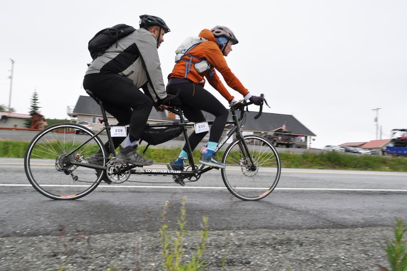 "The Grizzlies" two-person team, featuring Allison Suis and Nate Kile on a tandem bicycle, rides along the Glenn Highway past Eureka Lodge during the 200-mile Fireweed bike race to Valdez on Saturday, July 13, 2024. (Vicky Ho / ADN)