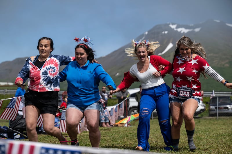 Racers, including Stephanie Summerville and Shonna Leal at right, compete in a three-legged race during the King Cove Independence Day celebration activities organized by the King Cove Women’s Club on July 3, 2024. (Marc Lester / ADN)
