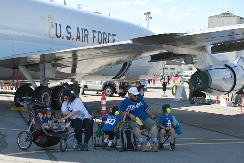 Vincio, Pamela, Carissa, (mom) Maximiliano, Luis, (father) and Gerardo Ochoa find shade from a AWAC Air Force plane during the Arctic Thunder Open House at JBER on Saturday. (Bob Hallinen Photo)
