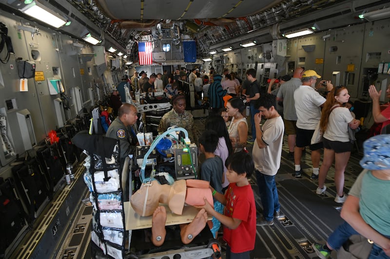 People get an inside look at an Air National Guard C-17 with a display of the Critical Care Air Transport Team set up inside the aircraft at JBER on Saturday. (Bob Hallinen Photo)
