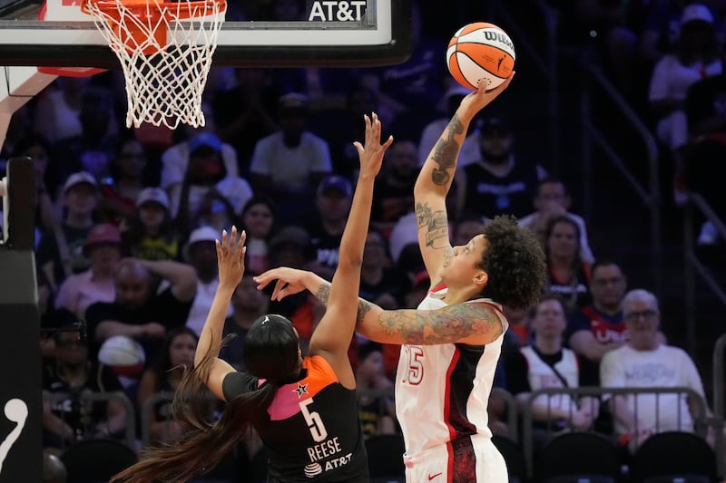 Brittney Griner (15), of Team USA, shoots over Angel Reese (5), of Team WNBA, during the second half of a WNBA All-Star basketball game Saturday, July 20, 2024, in Phoenix. (AP Photo/Ross D. Franklin)