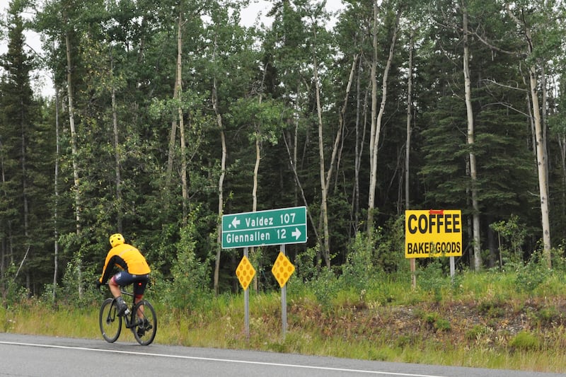 A member of the four-person "Alaska Boy Band" team rides along the Richardson Highway just south of Glennallen during the 200-mile bicycle race to Valdez on Saturday, July 13, 2024. (Vicky Ho / ADN)