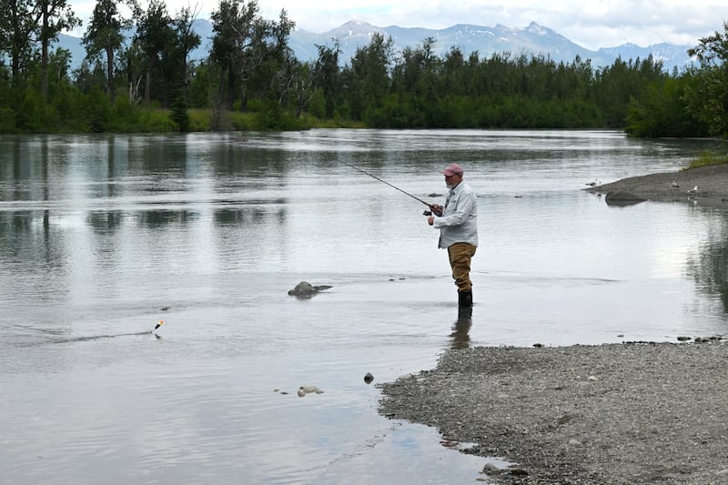 Raymond Boniface of Wasilla retrieves his line while fishing for King salmon at the Eklutna Tailrace on Wednesday, July 10, 2024. (Bill Roth / ADN)