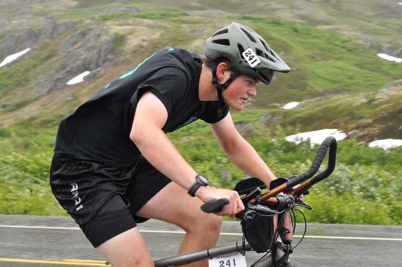 Zach Weatherby, a member of the "Weatherby" duo in the 200-mile Fireweed bicycle race to Valdez, climbs uphill along the Richardson Highway near Thompson Pass on Saturday, July 13, 2024. (Vicky Ho / ADN)