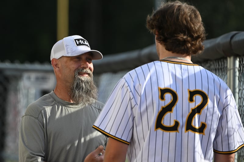 Shane Mattingly speaks with Jacob Rebrook during the Anchorage Bucs' 12-2 victory over the Peninsula Oilers at Mulcahy Stadium on Thursday, July, 13, 2023. Mattingly hosted Rebrook for a few days at the beginning of the ABL season. (Bill Roth / ADN) 