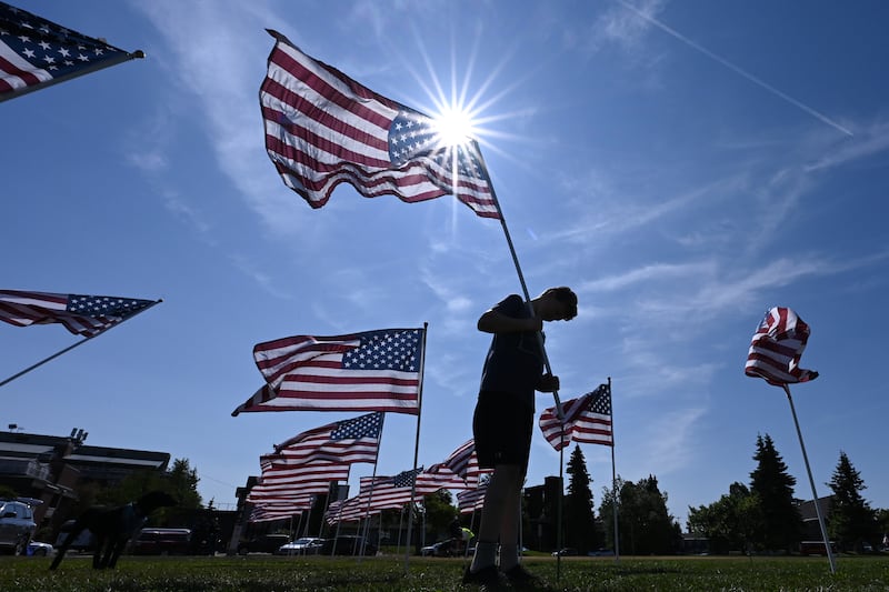 Jack Cosby, 12, helped place 500 American flags at the Delaney Park Strip on Wednesday, July 3, 2024, in preparation for the 2nd annual Field of Honor fundraiser event organized by Anchorage International Rotary Club on Independence Day. (Bill Roth / ADN)