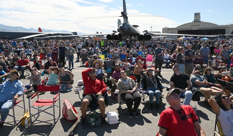 A large crowd watches the US Army Golden Knights parachute team during the Arctic Thunder Open House at Joint Base Elmendorf Richardson in Anchorage on Saturday. (Bob Hallinen Photo)
